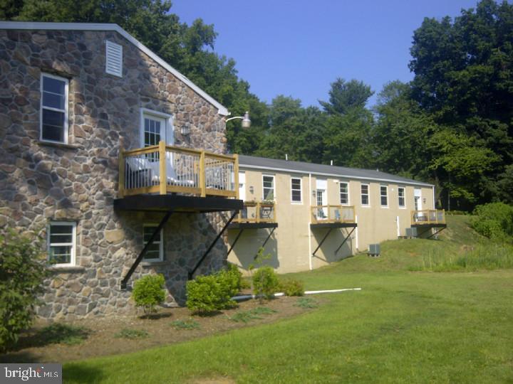 85 Valley Road, Unit 1 Phoenixville, PA 19460 - Photo 21 of 28 a front view of house with yard and trees in the background