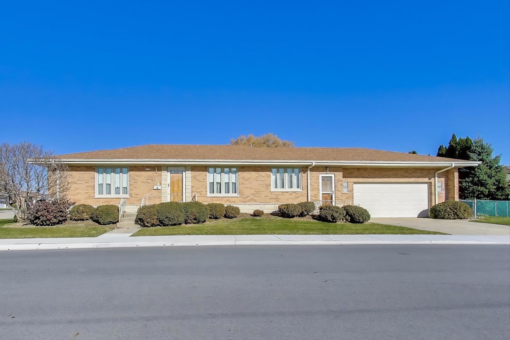 a front view of a house with a garden and plants