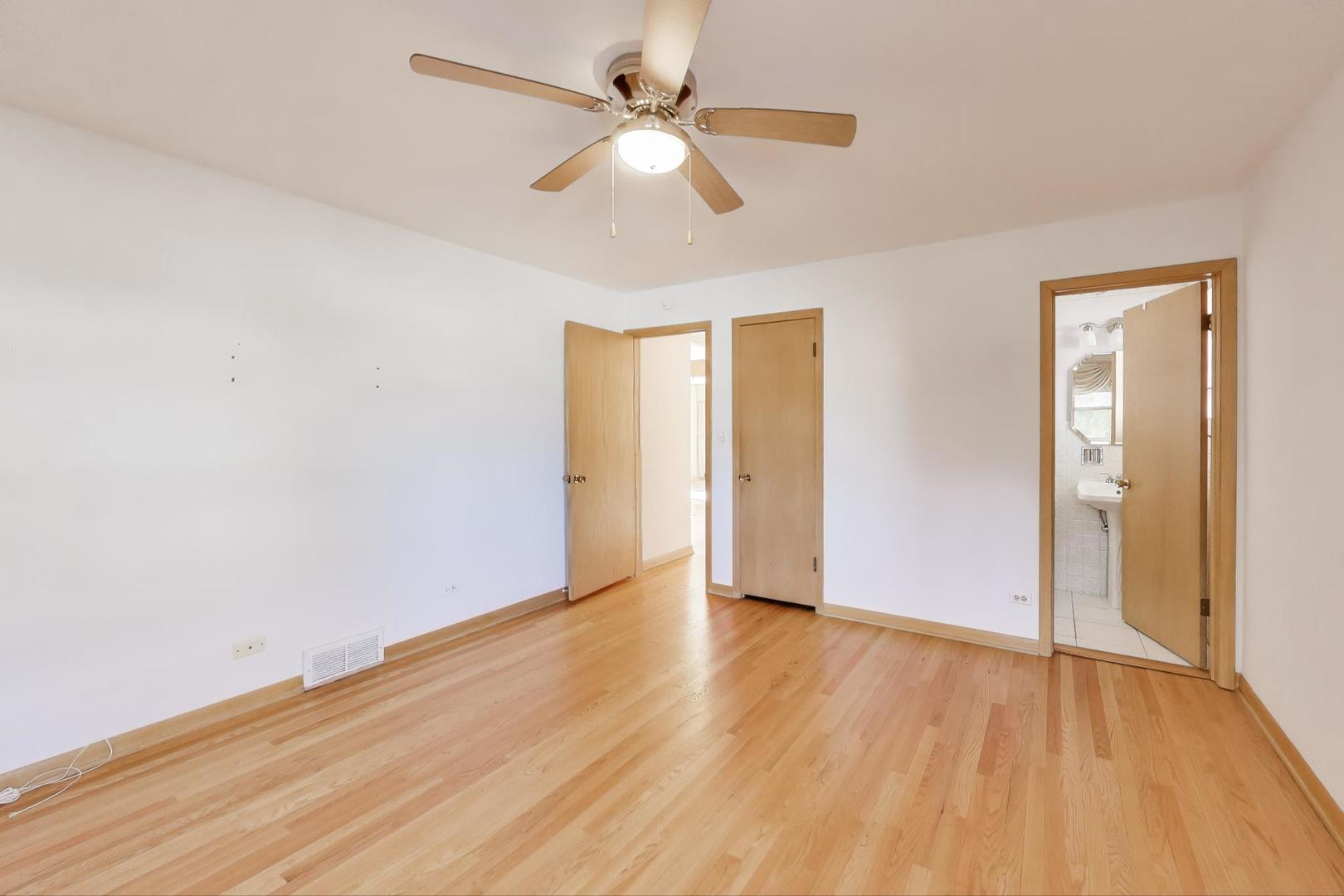 Undisclosed Address Chicago, IL 60656 - Photo 14 of 37 an empty room with wooden floor ceiling fan and windows