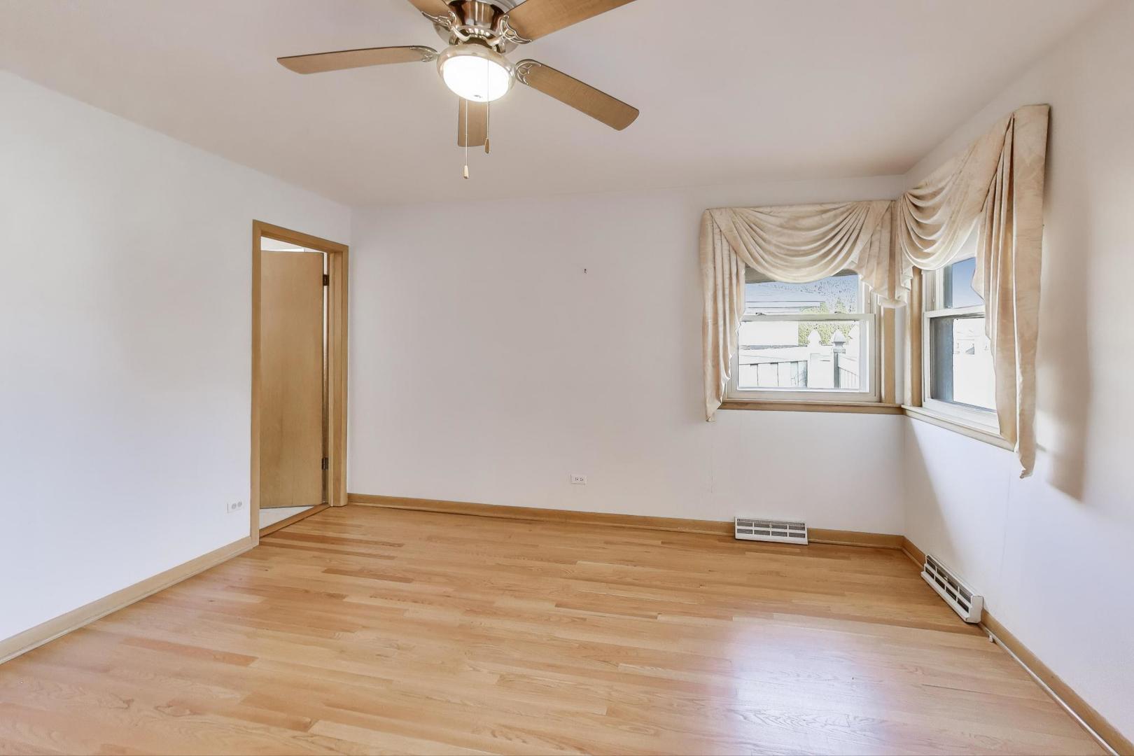 Undisclosed Address Chicago, IL 60656 - Photo 16 of 37 an empty room with windows and fan