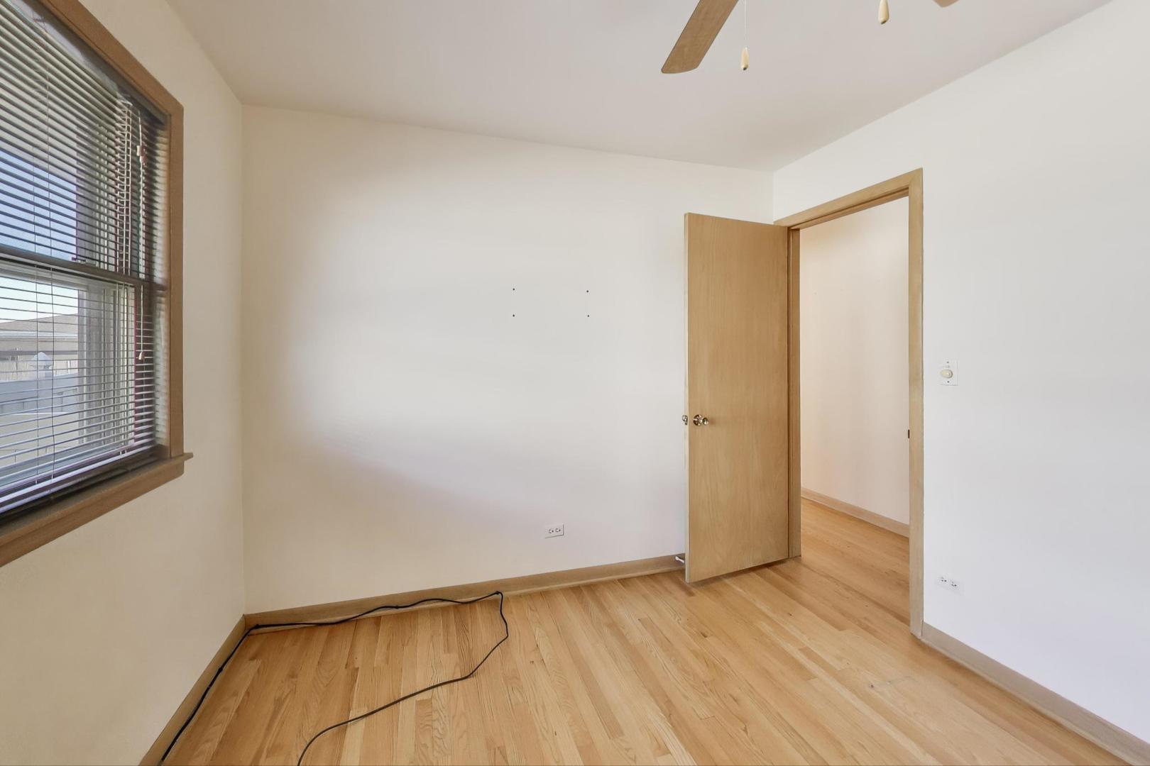Undisclosed Address Chicago, IL 60656 - Photo 21 of 37 an empty room with wooden floor and windows