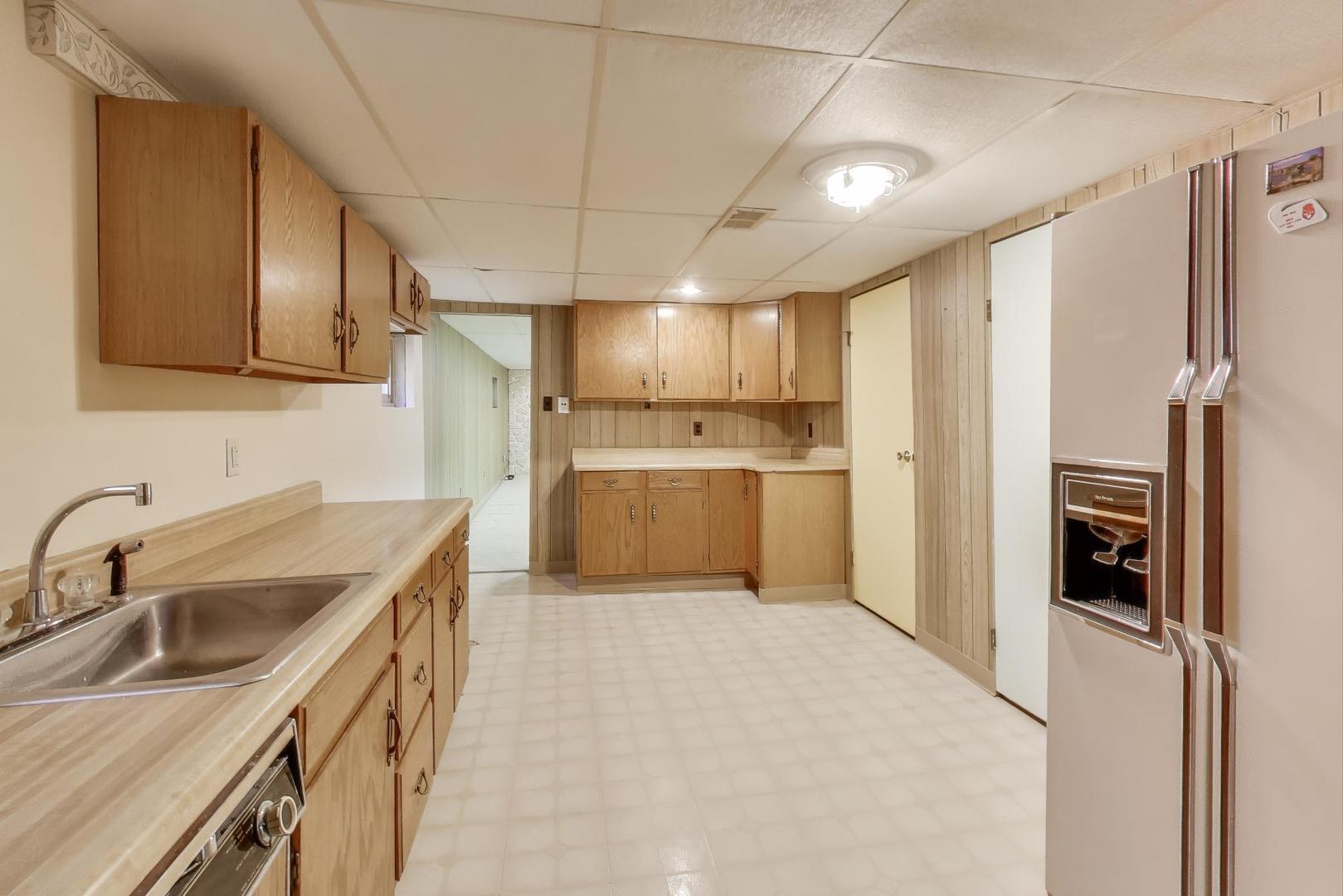 Undisclosed Address Chicago, IL 60656 - Photo 28 of 37 a kitchen with a sink refrigerator and cabinets