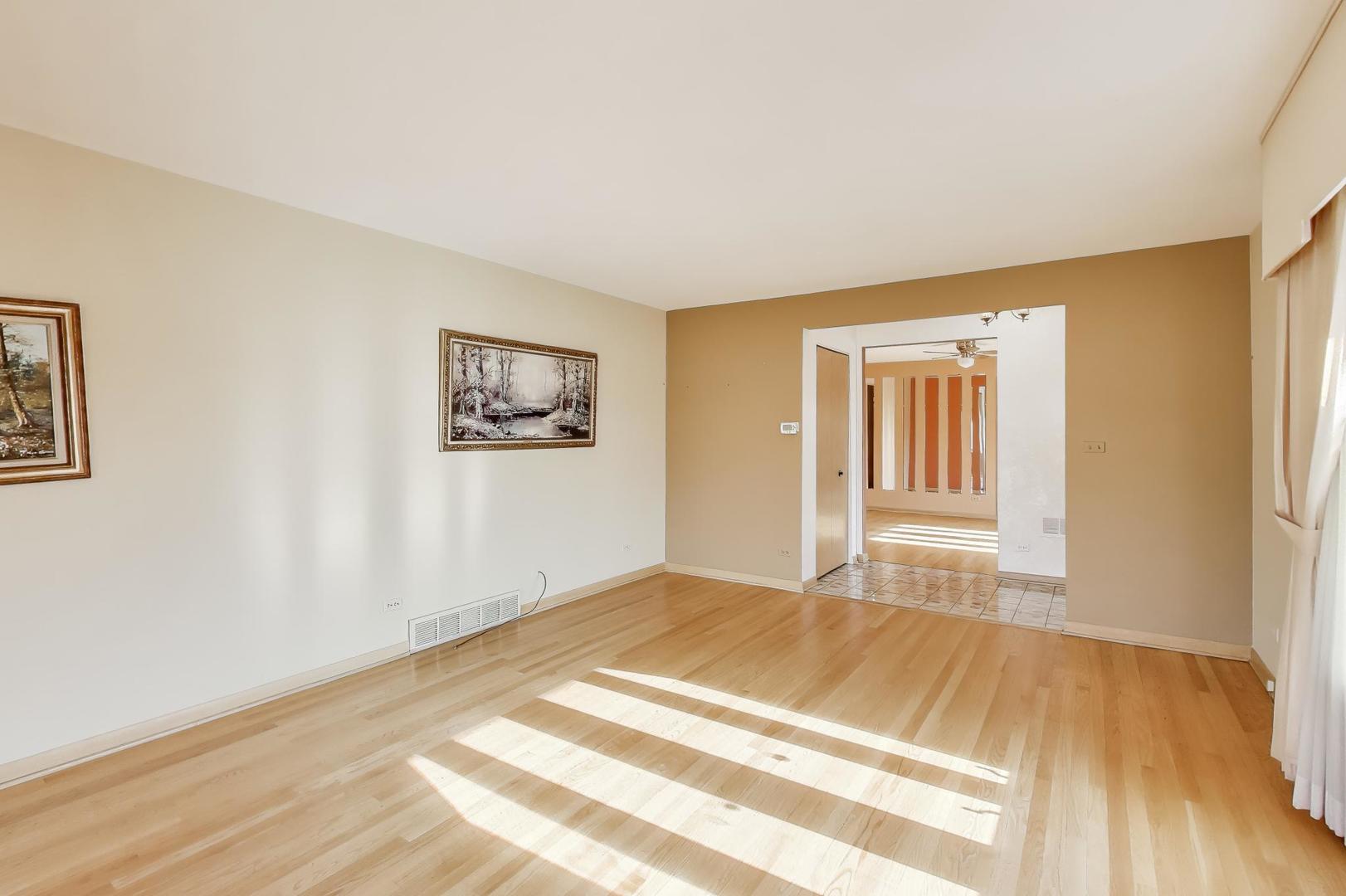 Undisclosed Address Chicago, IL 60656 - Photo 6 of 37 a view of an empty room with wooden floor and a window