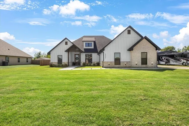 a front view of house with yard and green space