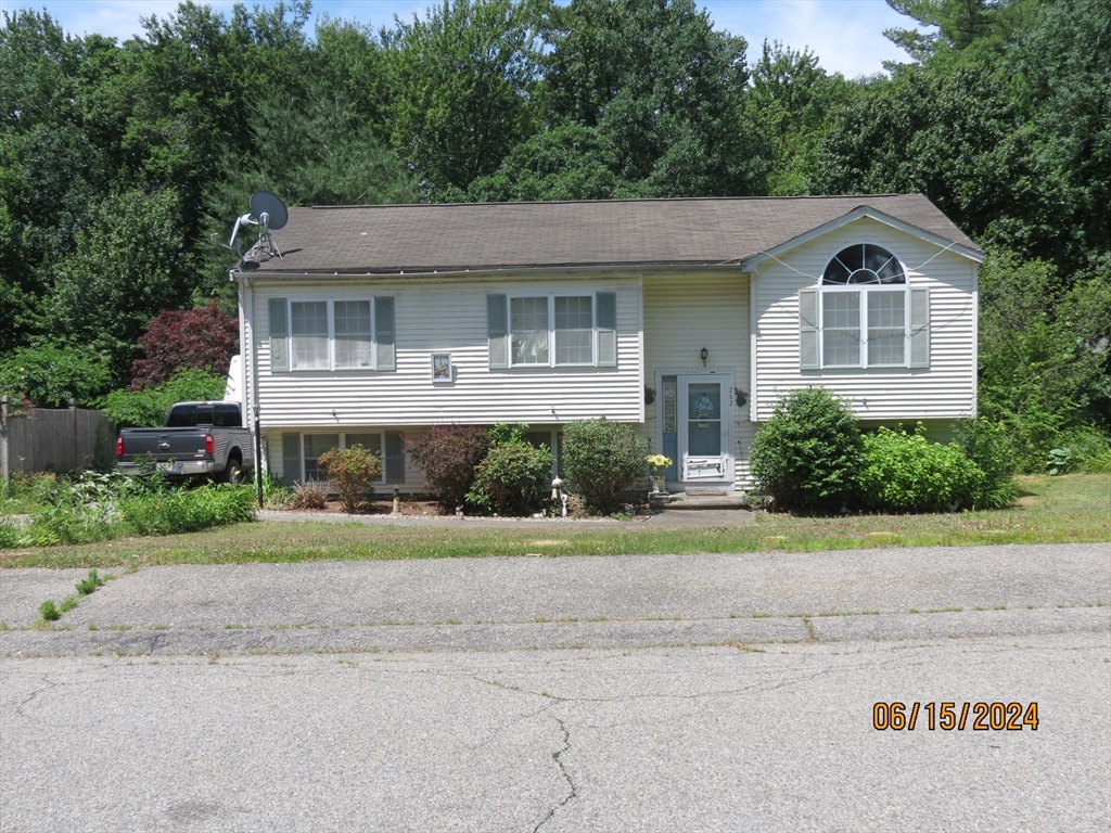262 Acropolis Road Lowell, MA 01854 - Photo 1 of 31 a front view of a house with a yard