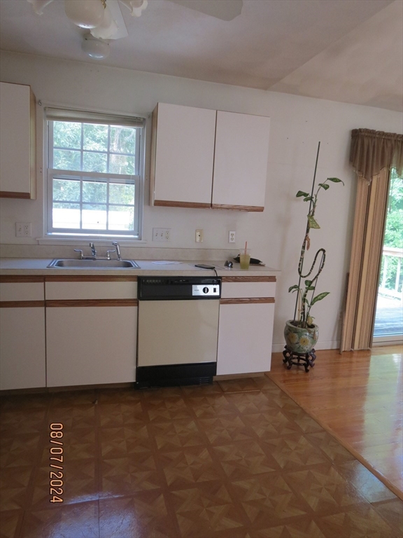 262 Acropolis Road Lowell, MA 01854 - Photo 11 of 31 a kitchen with a sink cabinets and a window