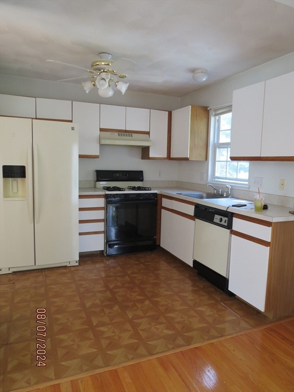 262 Acropolis Road Lowell, MA 01854 - Photo 12 of 31 a kitchen with stainless steel appliances a stove a sink and a refrigerator