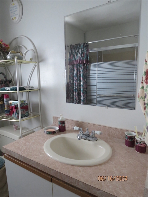 262 Acropolis Road Lowell, MA 01854 - Photo 15 of 31 a bathroom with a sink and a mirror
