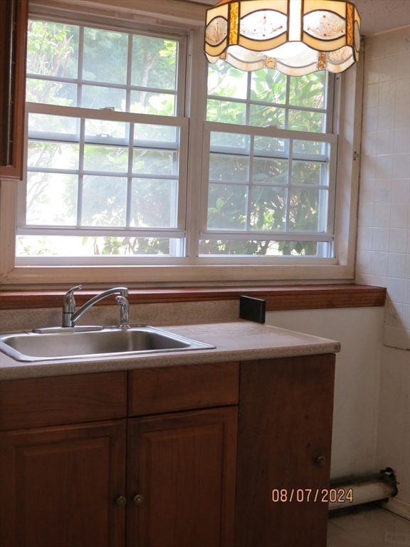 262 Acropolis Road Lowell, MA 01854 - Photo 28 of 31 a view of a sink a window and a cabinet