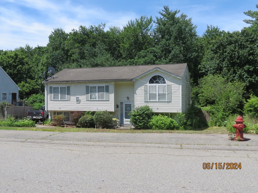 262 Acropolis Road Lowell, MA 01854 - Photo 3 of 31 a front view of a house with a garden