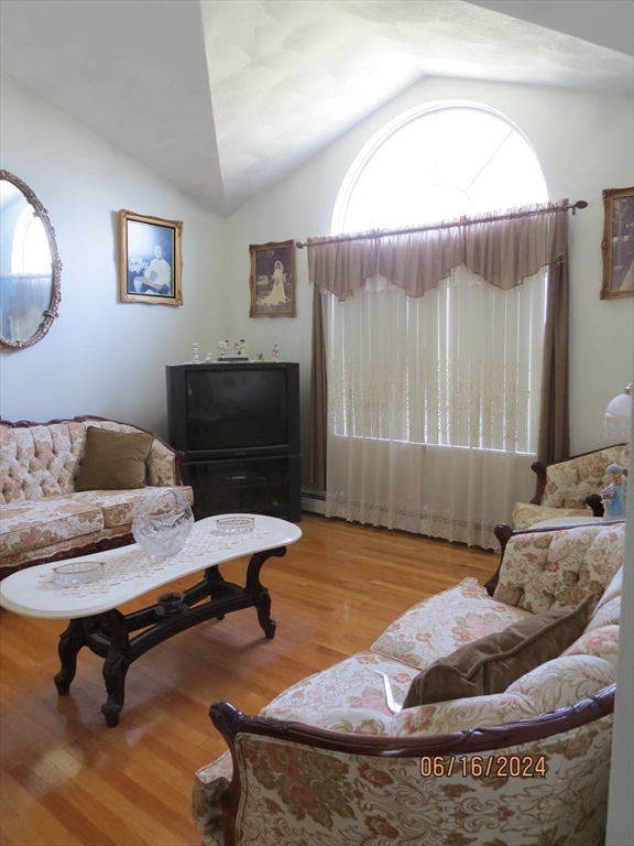 262 Acropolis Road Lowell, MA 01854 - Photo 6 of 31 a living room with a couch and a table