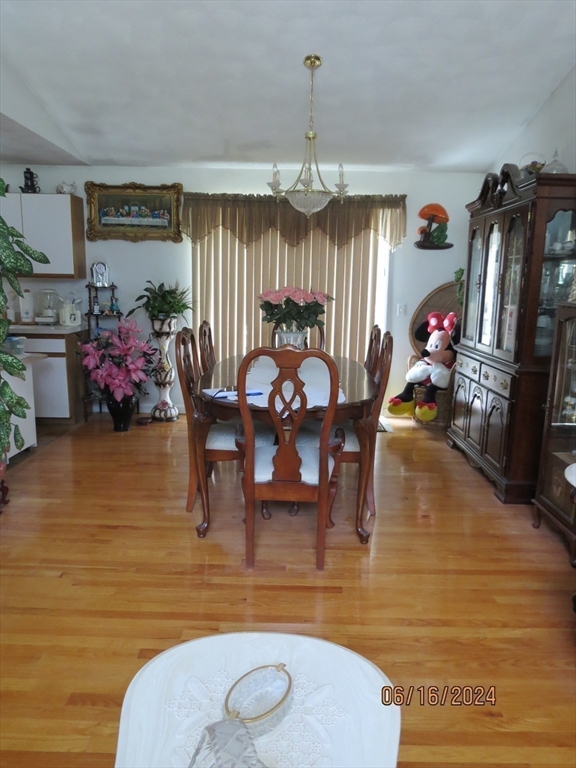 262 Acropolis Road Lowell, MA 01854 - Photo 8 of 31 a living room filled with furniture a chandelier a rug and a window
