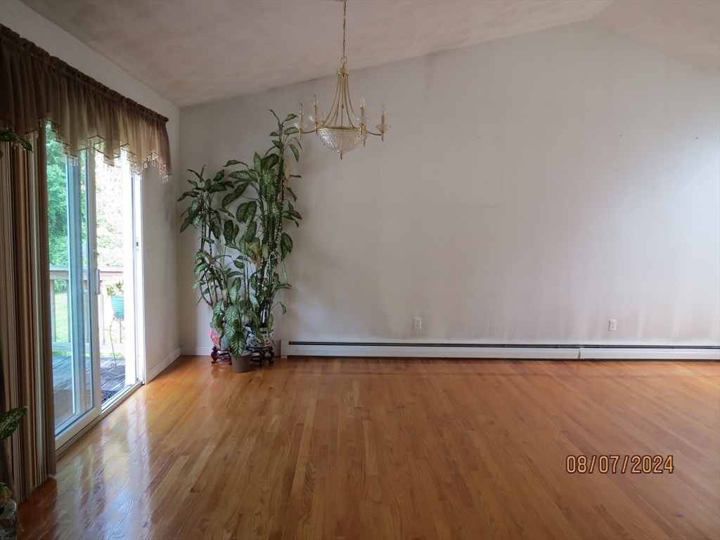 262 Acropolis Road Lowell, MA 01854 - Photo 10 of 31 a view of an empty room with a window and wooden floor