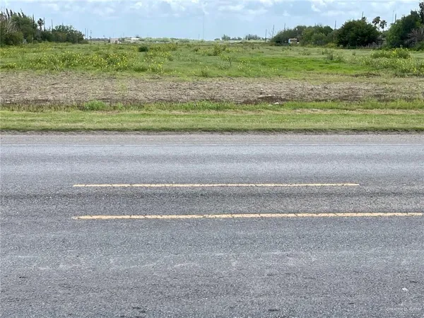 a view of a field with an ocean beach