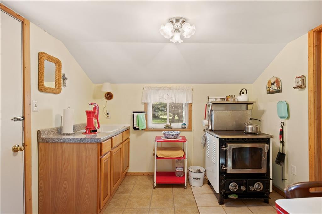 154 Findley Street New Baltimore, PA 15553 - Photo 11 of 32 a kitchen that has a lot of cabinets a washer and dryer