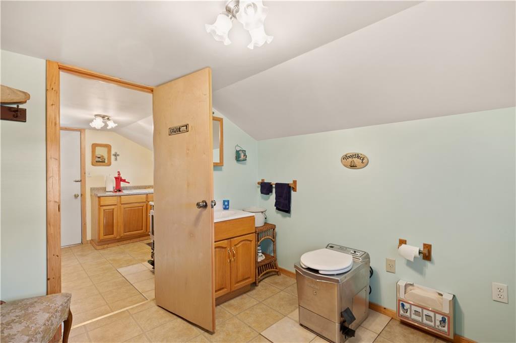154 Findley Street New Baltimore, PA 15553 - Photo 15 of 32 a room with a chair and white appliances