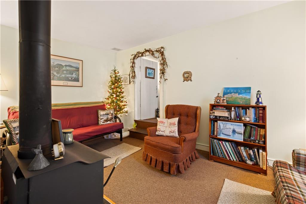 154 Findley Street New Baltimore, PA 15553 - Photo 7 of 32 a living room with furniture a bookshelf and a window