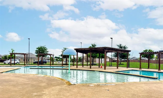 a view of swimming pool with a patio