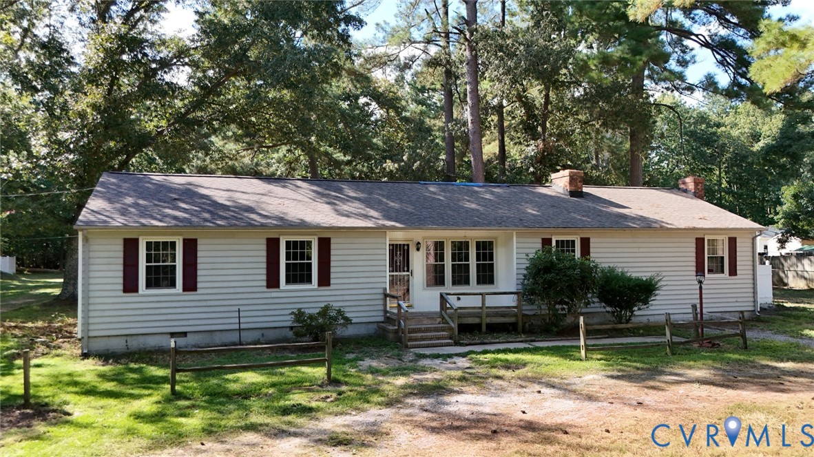 17406 Sandy Ford Road Chesterfield, VA 23838 - Photo 1 of 23 a backyard of a house with plants and large tree