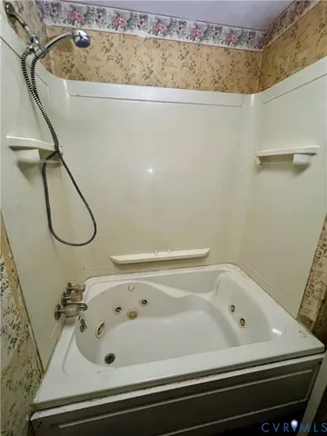 a bathroom with a bath tub and a shower