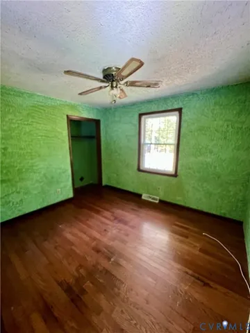 a view of a big room with windows and fireplace