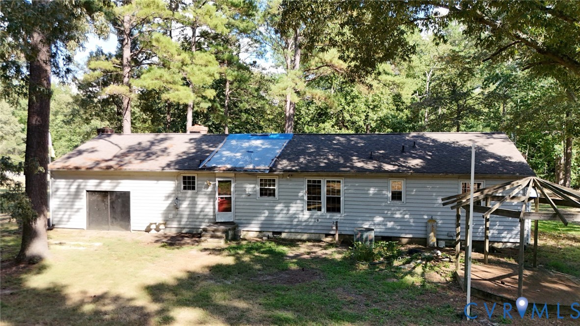 17406 Sandy Ford Road Chesterfield, VA 23838 - Photo 2 of 23 a backyard of a house with table and chairs under an large tree