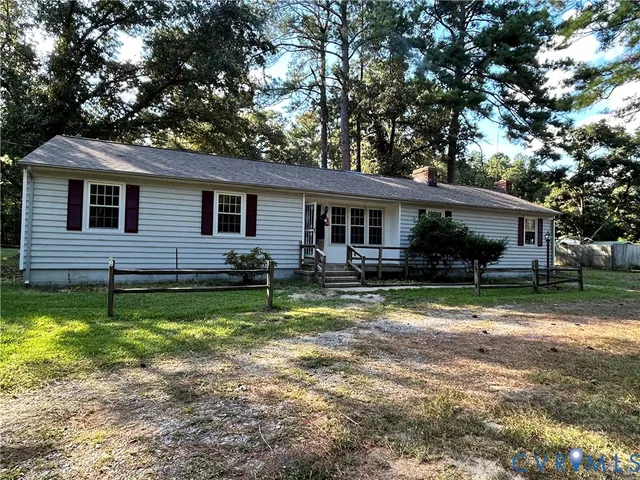 a backyard of a house with yard and tree