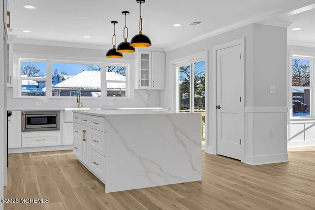 a kitchen with stainless steel appliances granite countertop a sink a stove and a refrigerator