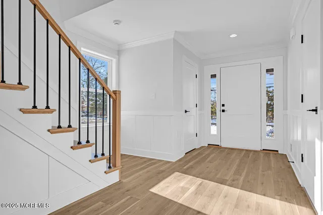 a view of entryway with wooden floor and stair