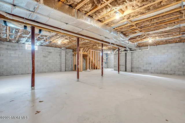 a view of house with backyard and trees in the background