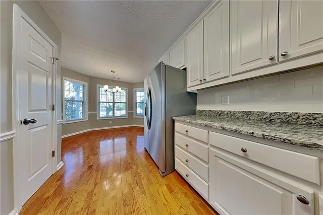 a spacious bathroom with stainless steel appliances granite countertop a refrigerator and a stove