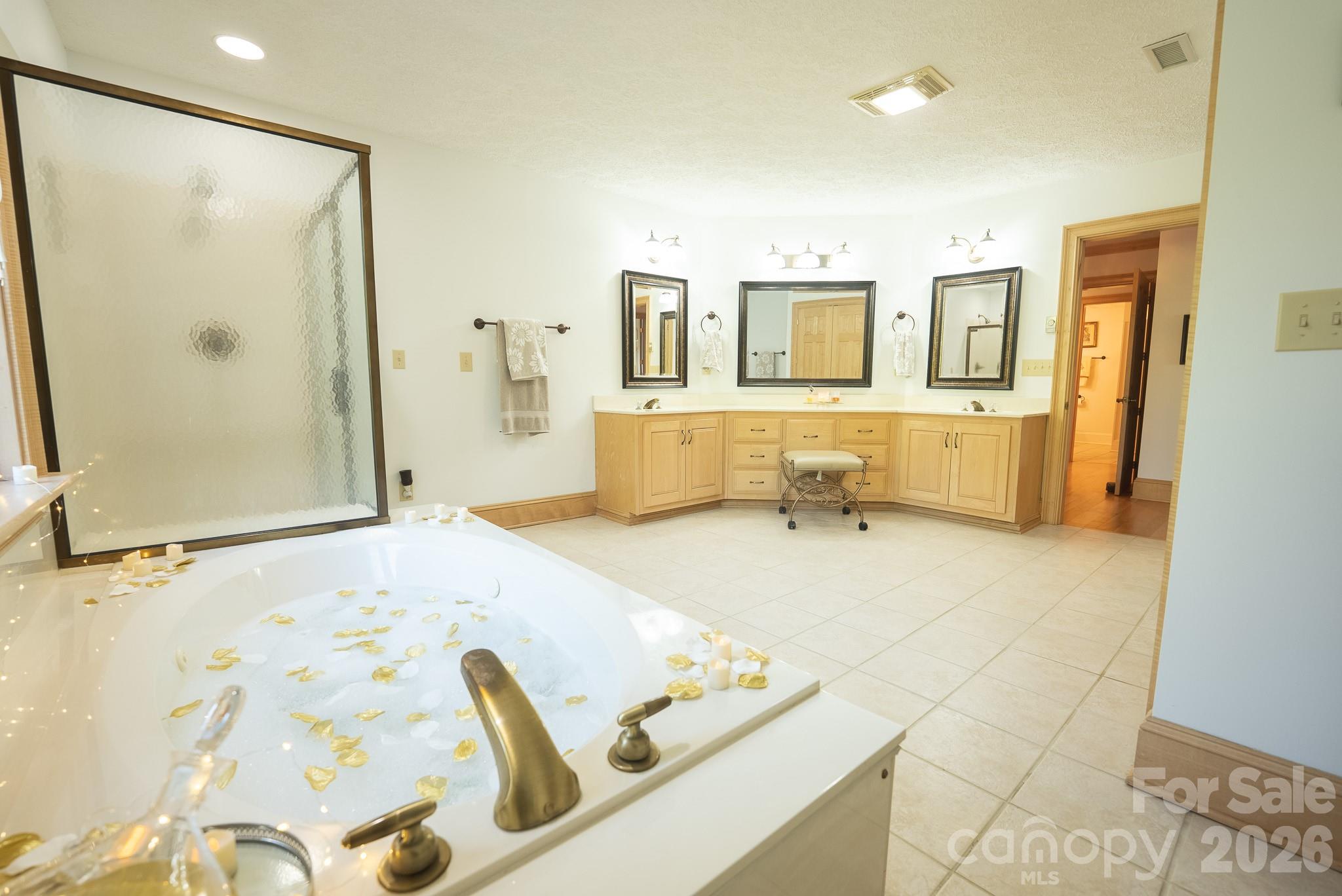 6985 Junaluska Road Boone, NC 28607 - Photo 13 of 35 a bathroom with a tub sink and mirror