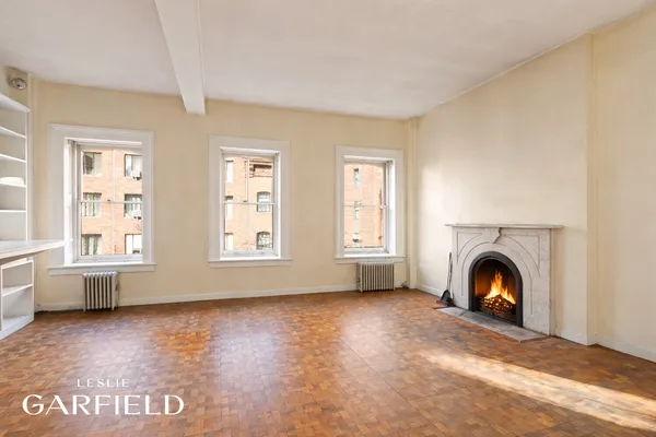 a view of an empty room and wooden floor