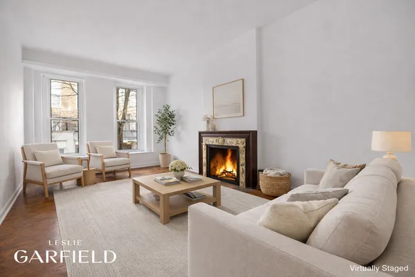 a view of an empty room with a fireplace and a window
