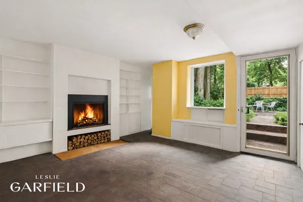 a view of empty room with fireplace and wooden floor