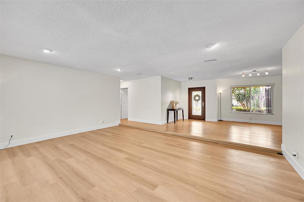 1480 Southwest 66th Terrace Plantation, FL 33317 - Photo 14 of 73 a view of an empty room with window and wooden floor