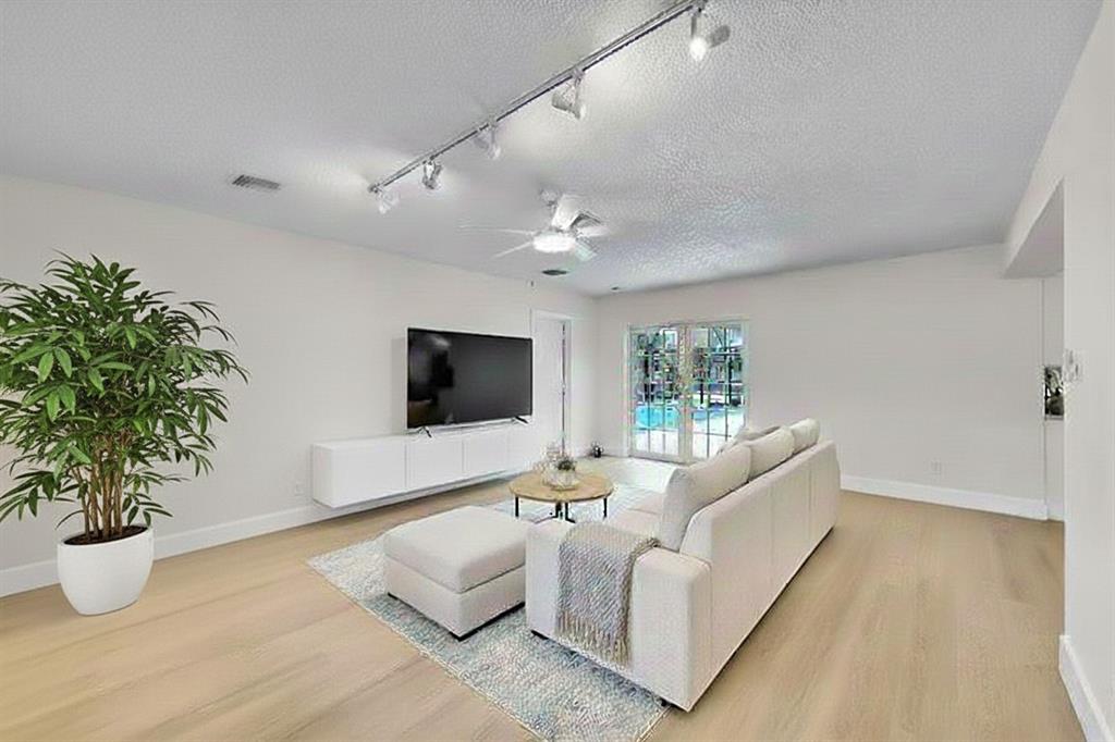 1480 Southwest 66th Terrace Plantation, FL 33317 - Photo 29 of 73 a living room with furniture and a flat screen tv