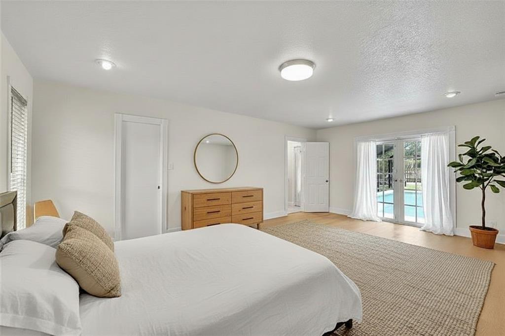 1480 Southwest 66th Terrace Plantation, FL 33317 - Photo 36 of 73 a bedroom with a large bed and wooden floor