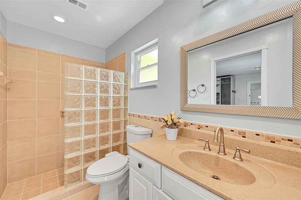 1480 Southwest 66th Terrace Plantation, FL 33317 - Photo 37 of 73 a bathroom with a sink toilet mirror and shower