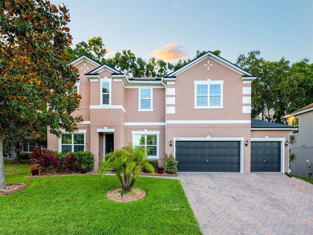 925 Counts Crest Circle Apopka, FL 32712 - Photo 1 of 36 a front view of a house with a garden and yard