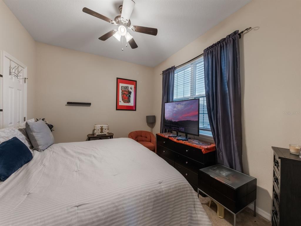 925 Counts Crest Circle Apopka, FL 32712 - Photo 11 of 36 a bedroom with a bed and a flat screen tv