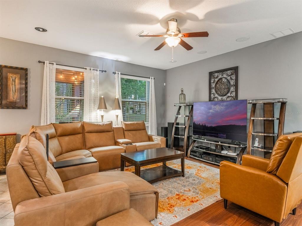 925 Counts Crest Circle Apopka, FL 32712 - Photo 18 of 36 a living room with furniture a flat screen tv and a large window