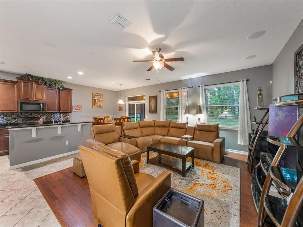 925 Counts Crest Circle Apopka, FL 32712 - Photo 19 of 36 a living room with fireplace furniture and a flat screen tv