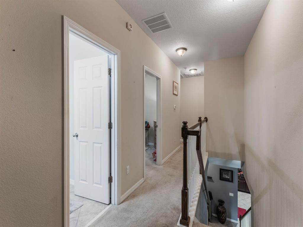 925 Counts Crest Circle Apopka, FL 32712 - Photo 28 of 36 a view of a hallway with two mirror and furniture