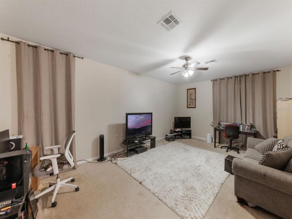 925 Counts Crest Circle Apopka, FL 32712 - Photo 29 of 36 a view of a livingroom with furniture and a flat screen tv