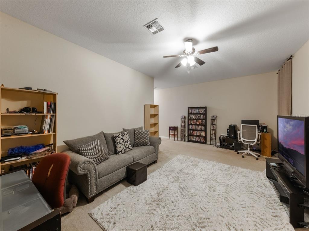 925 Counts Crest Circle Apopka, FL 32712 - Photo 30 of 36 a living room with furniture and a flat screen tv