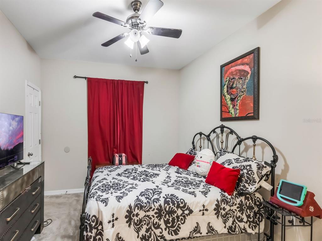 925 Counts Crest Circle Apopka, FL 32712 - Photo 31 of 36 a bedroom with a bed and a flat screen tv