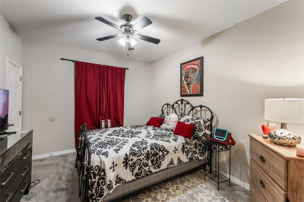 925 Counts Crest Circle Apopka, FL 32712 - Photo 32 of 36 a bedroom with bed and a chandelier