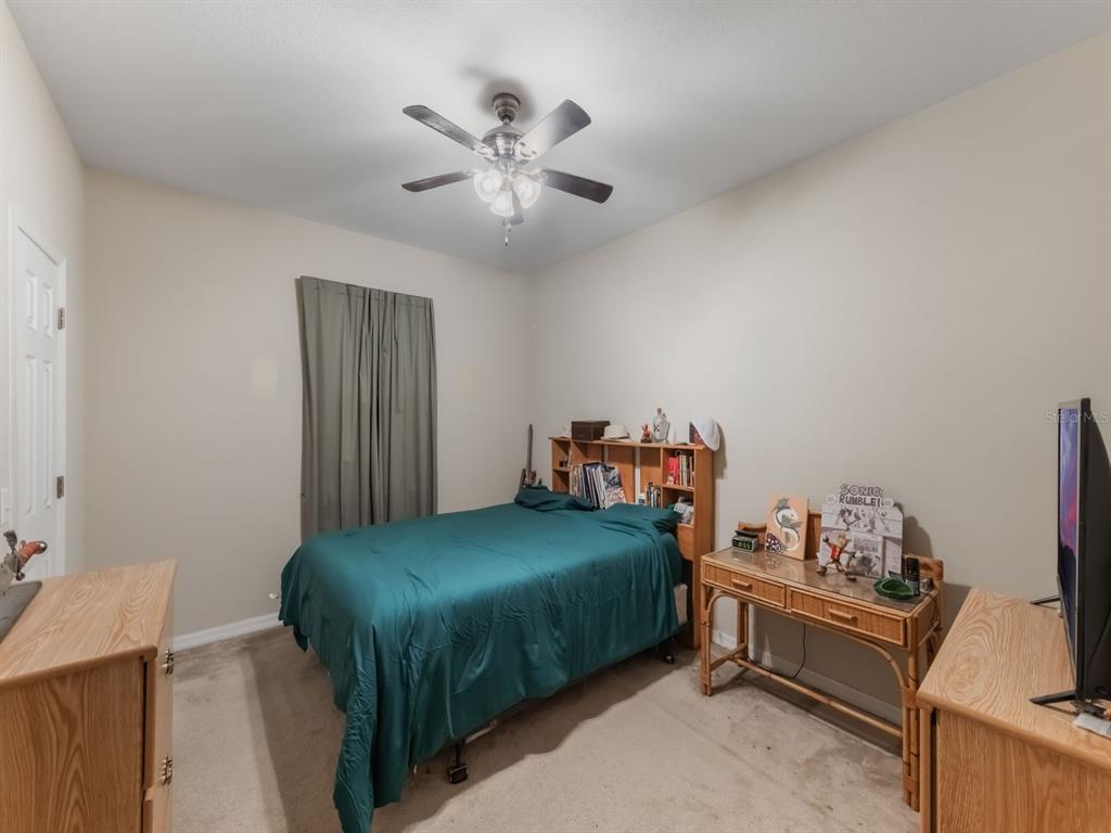 925 Counts Crest Circle Apopka, FL 32712 - Photo 33 of 36 a bedroom with a bed and a chandelier