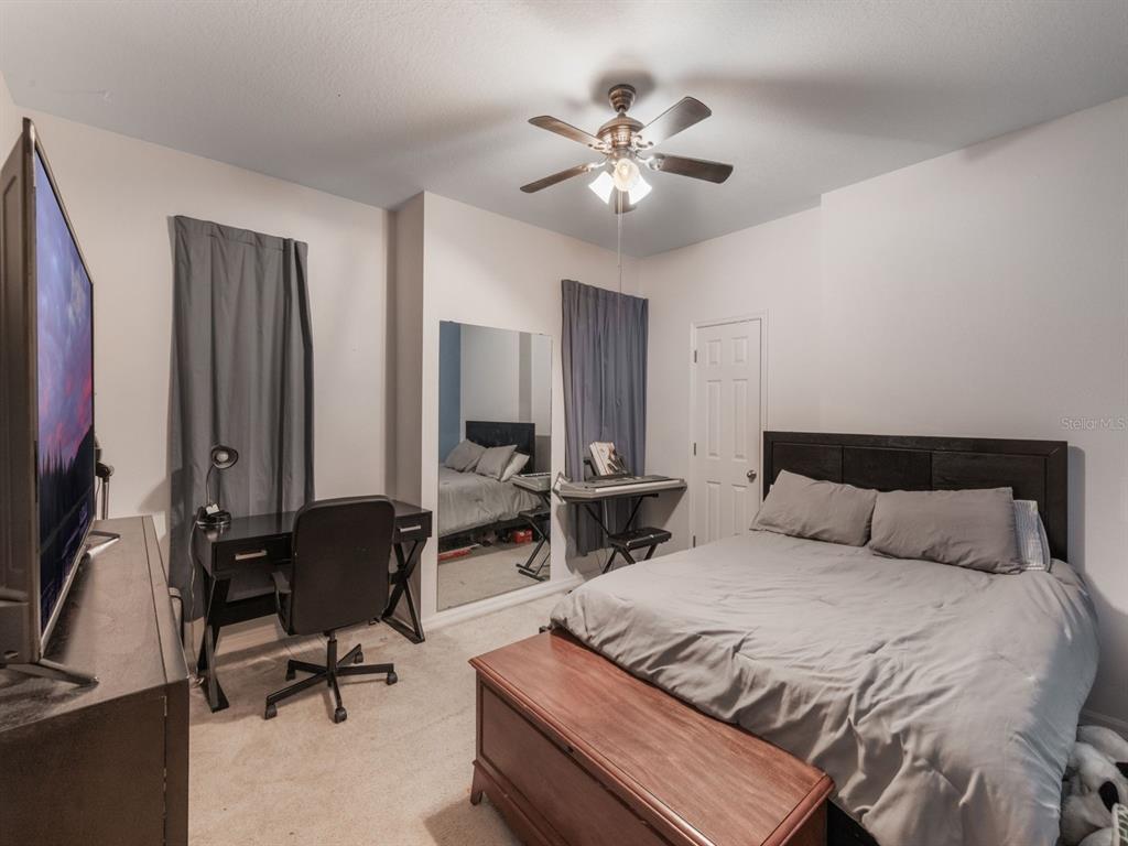 925 Counts Crest Circle Apopka, FL 32712 - Photo 34 of 36 a bedroom with a bed a desk and chair